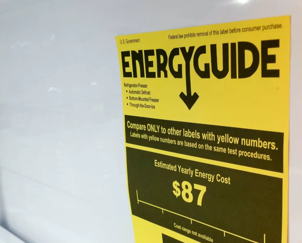 A yellow EnergyGuide label displayed inside a refrigerator.