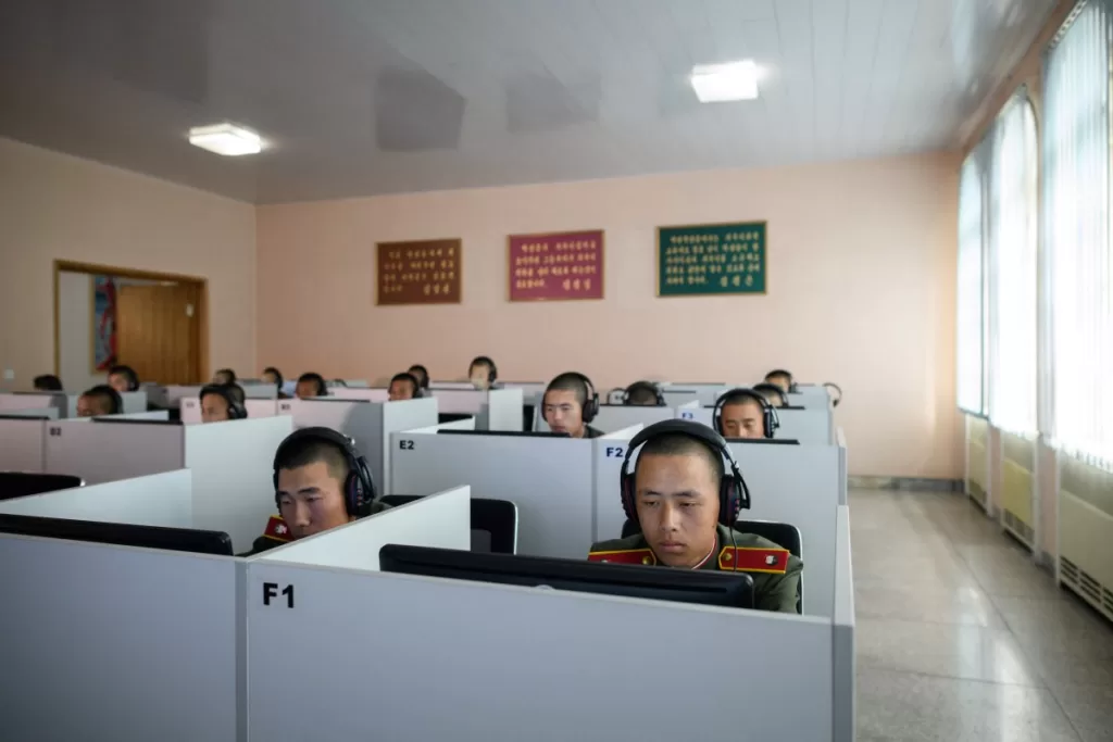 Students wearing Korean People's Army (KPA) uniforms sit before computer screens as they attend a class at the Mangyongdae Revolutionary School outside Pyongyang.