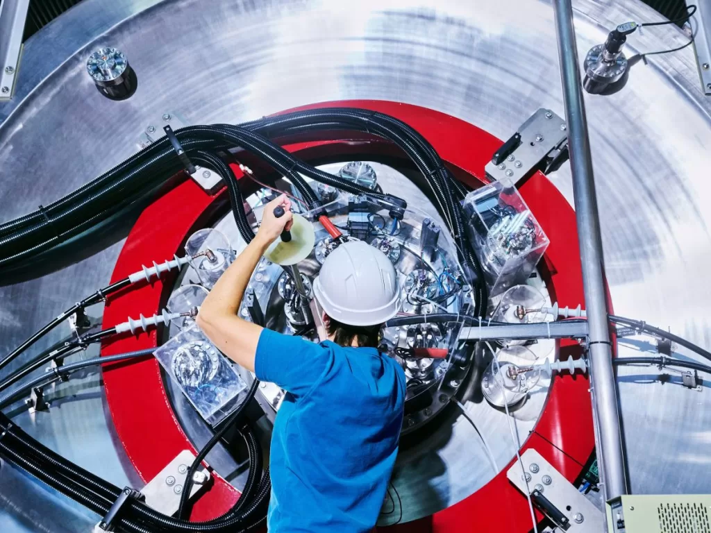 An employee is seen working on TAE Technologies’ fusion energy research device.