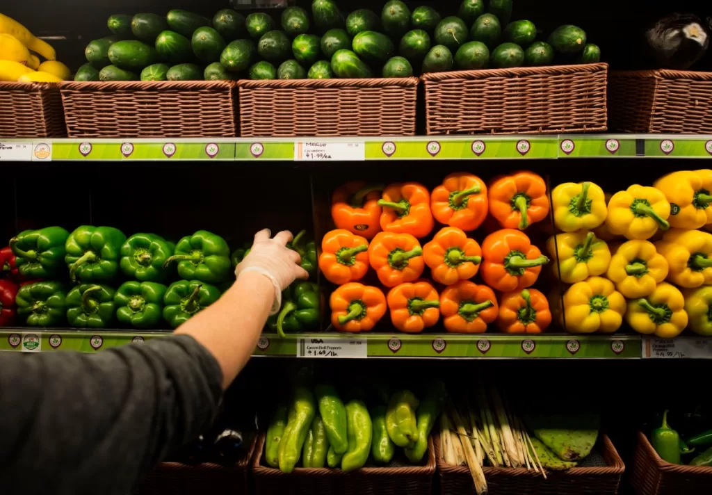 a file photo of a Whole Foods store shelf featuring fresh vegetables and bell peppers.