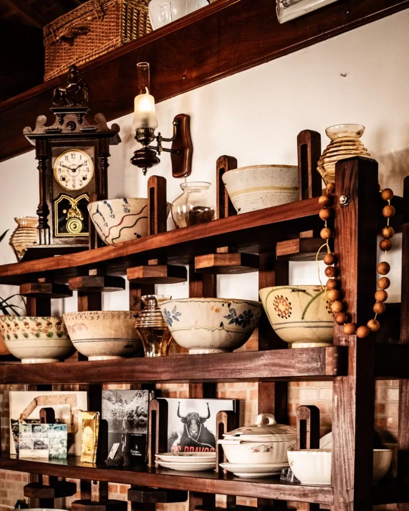 Image may contain Shelf Cabinet Furniture Indoors Interior Design Art Porcelain Pottery Wood Bread and Food