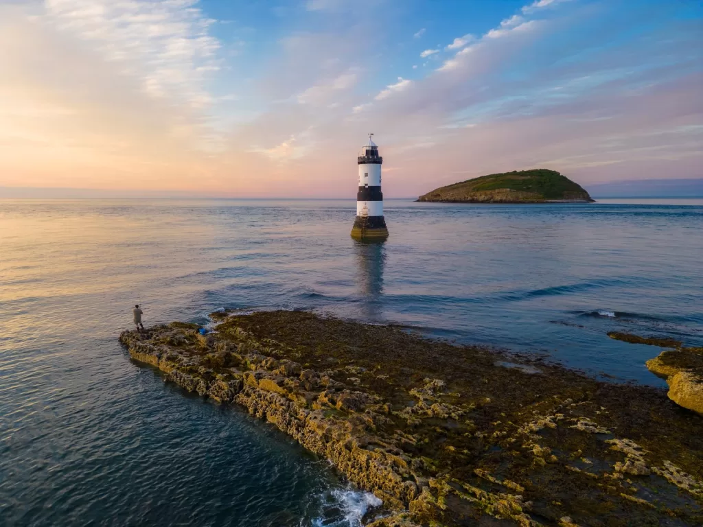 Image may contain Nature Outdoors Sea Water Sky Person Architecture Beacon Building Lighthouse Tower and Horizon