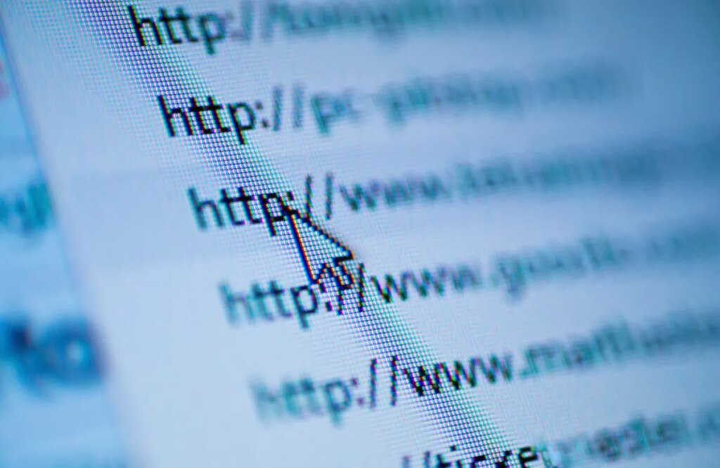 Cursor arrow pointing at URL on screen