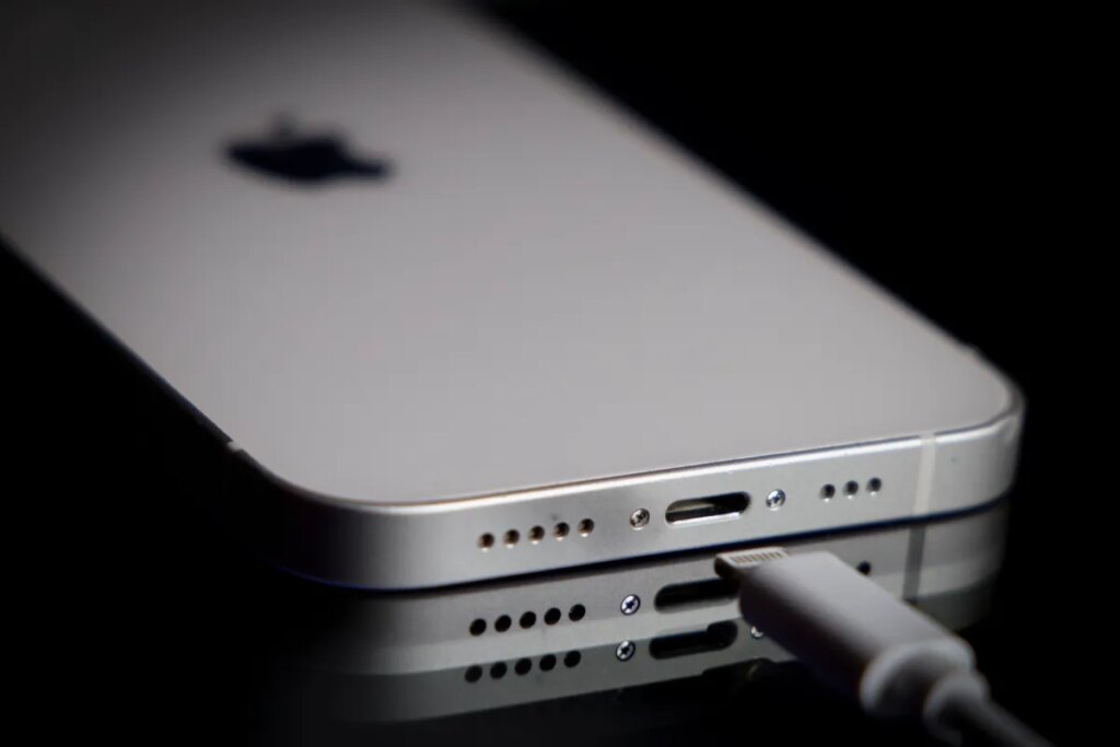 A Apple Lightning port charging cable is seen with with an iPhone.